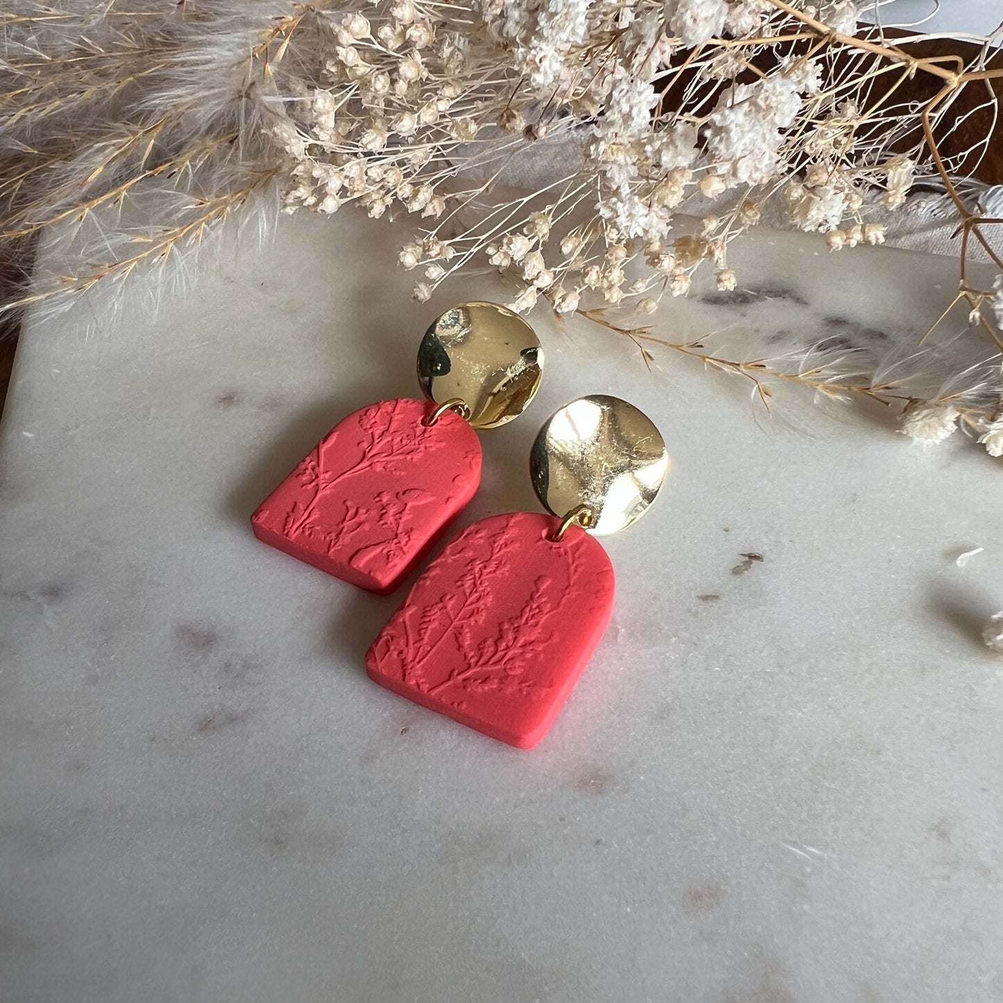DARAS | statement circle stud drop earring with blossom textured rounded arch in bright coral red