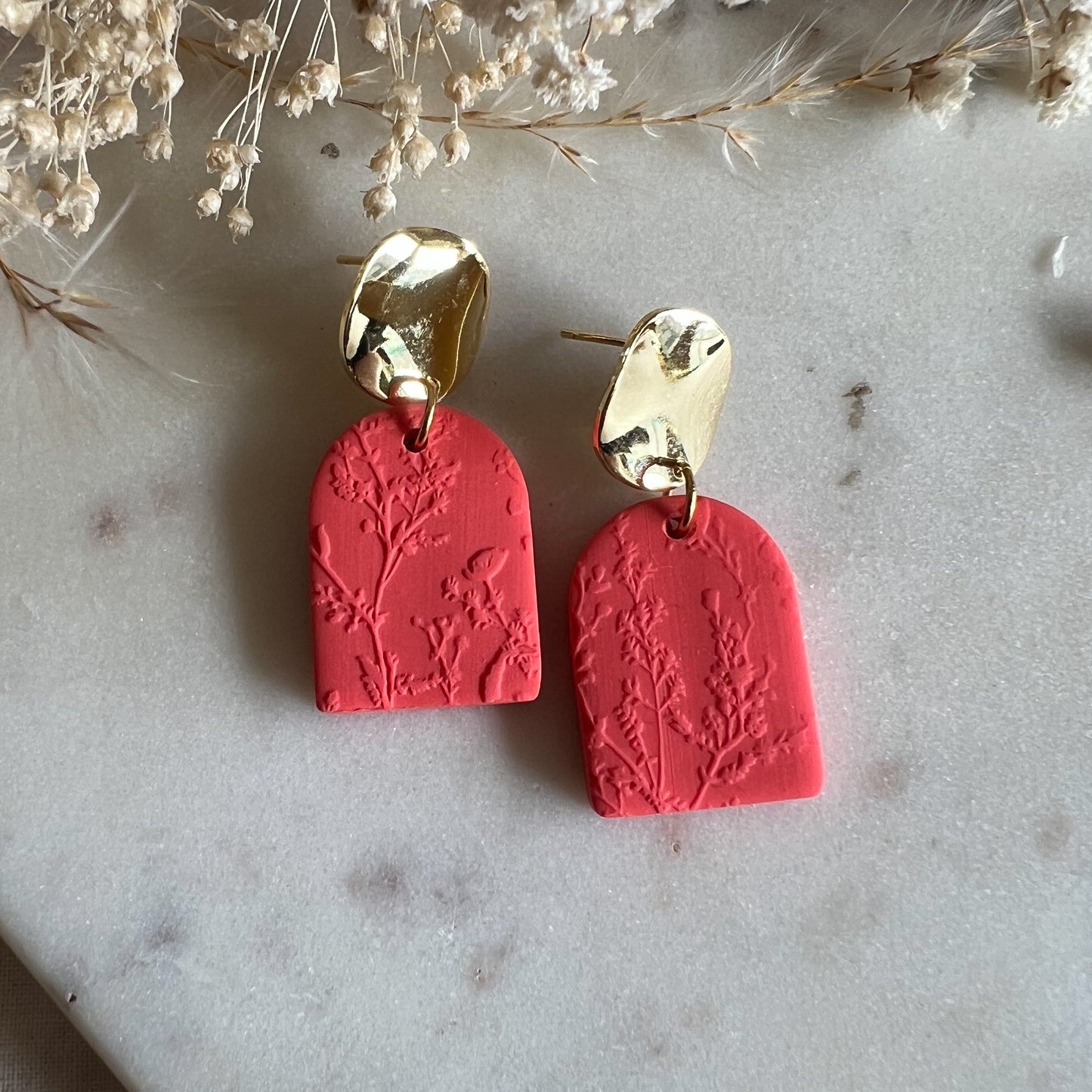 DARAS | statement circle stud drop earring with blossom textured rounded arch in bright coral red
